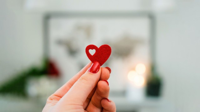 Red heart in Woman's hand