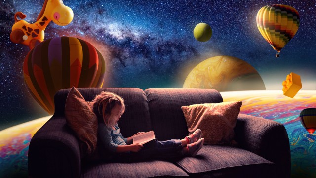 Cute Girl Reading book on Couch